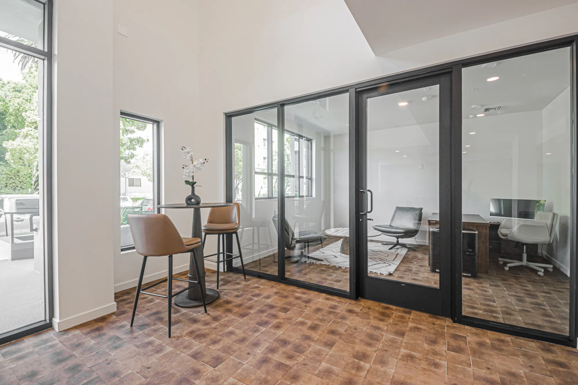 Co-working lounge with glass-walled office at The Gramercy