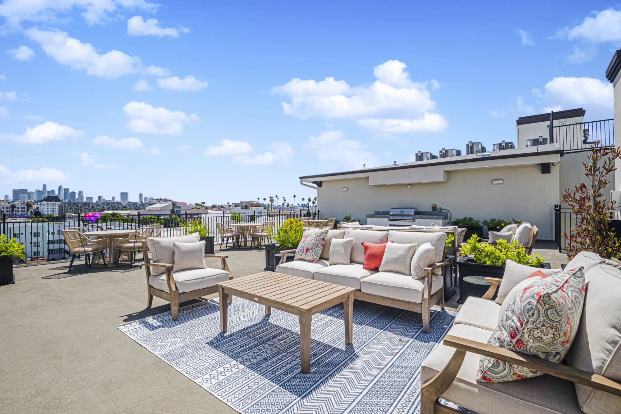 Rooftop deck with lounge seating and LA skyline views at The Gramercy